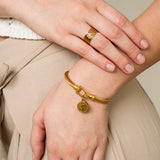 Bracciale dorato con motivo a moneta