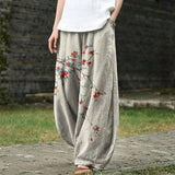 Dionisia - Pantaloni larghi beige con motivi a foglie rosse